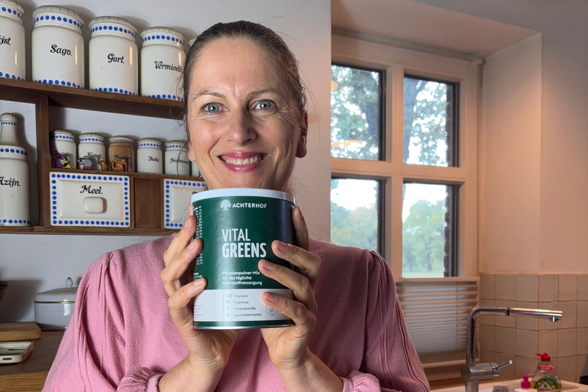 Vital Greens wird in ein Glas Wasser eingerührt